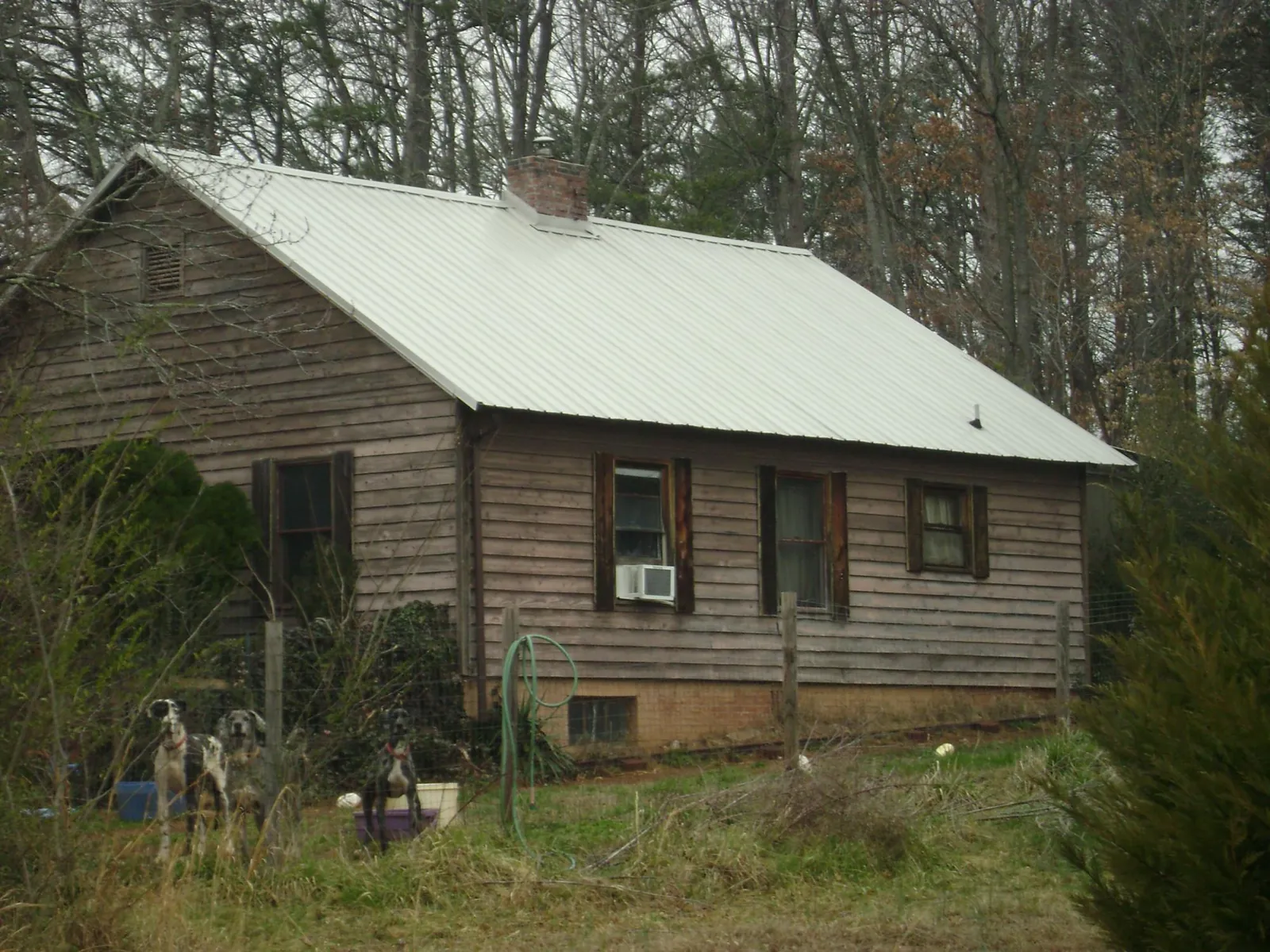White metal roof on an old wood sided farmhouse, from a Metal Roof Installation job in Lawrenceville
